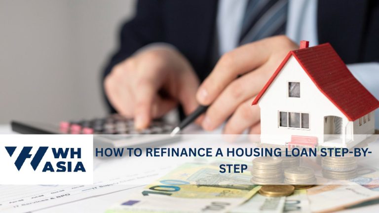 Photo of a man calculating how to refinance a housing loan, with a model house on the desk beside him.